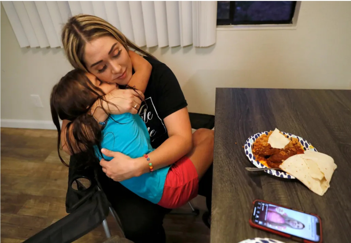 mother cradles child in lap