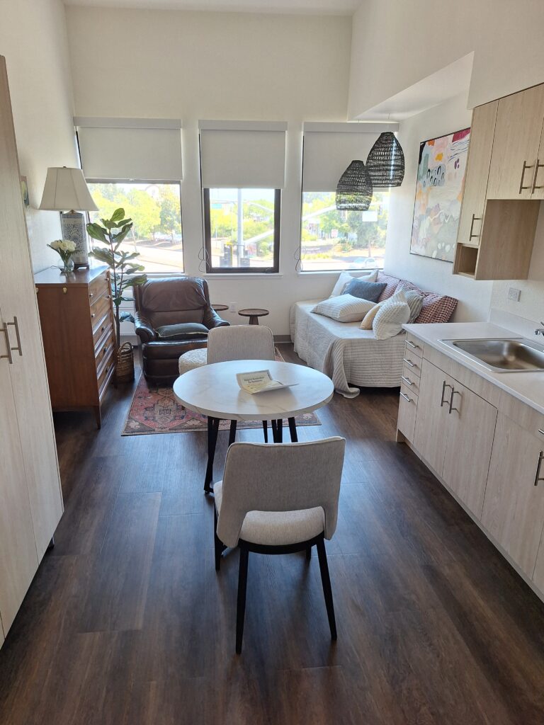 studio with table, easy chair, and couch / daybed.